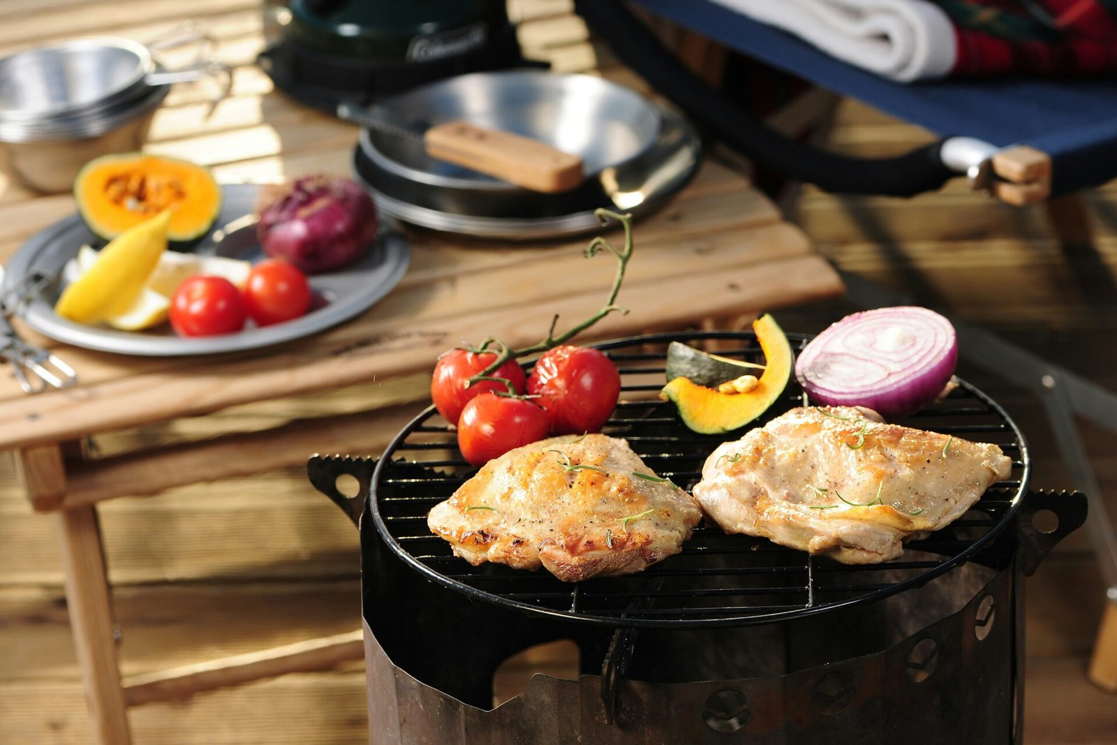 a grill with some meat and vegetables on it